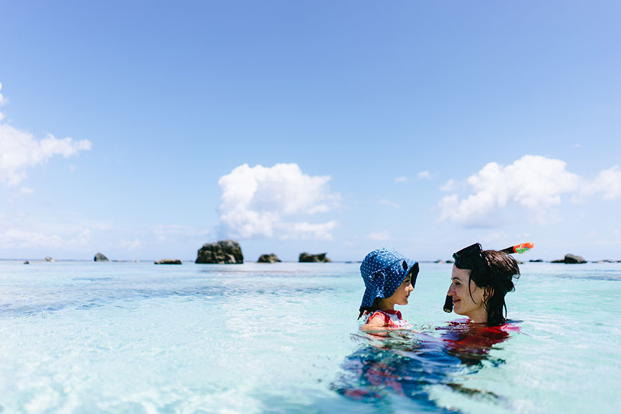 mother holding her child in the ocean