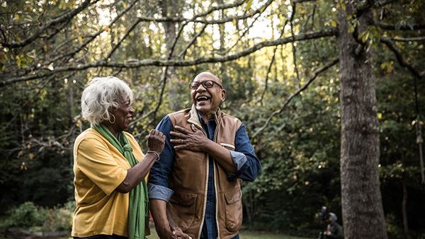 RetiredCoupleWalkingInForest