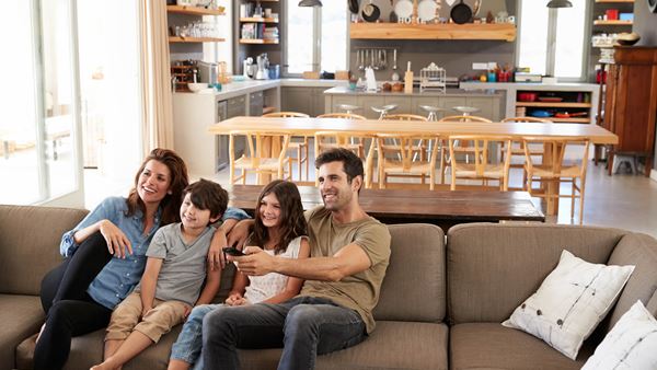 Family sat together on sofa