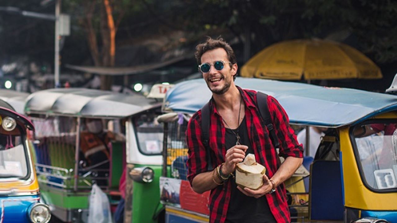 Backpacker with coconut in Thailand