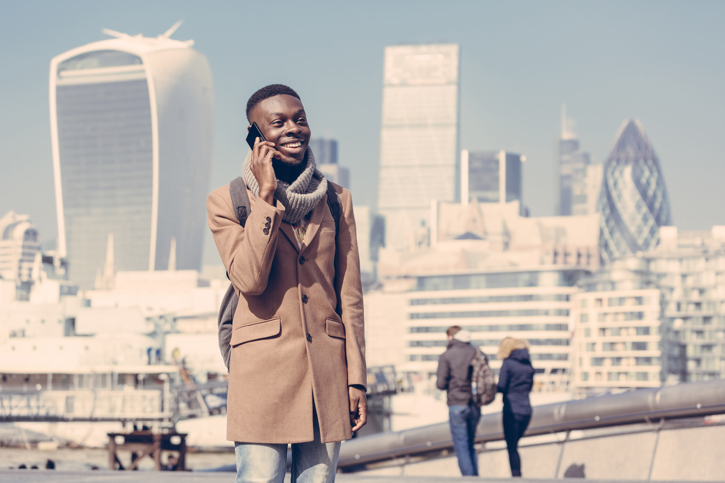 Man on phone with London city backdrop