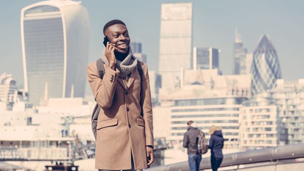 Man on phone with London city backdrop