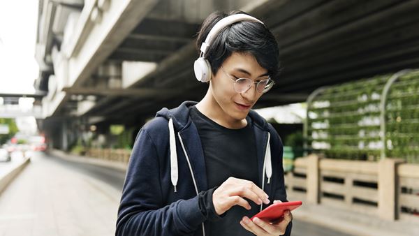 Man listening to music and looking at phone