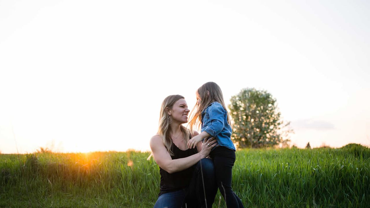 Mother and daughter playing in meadow