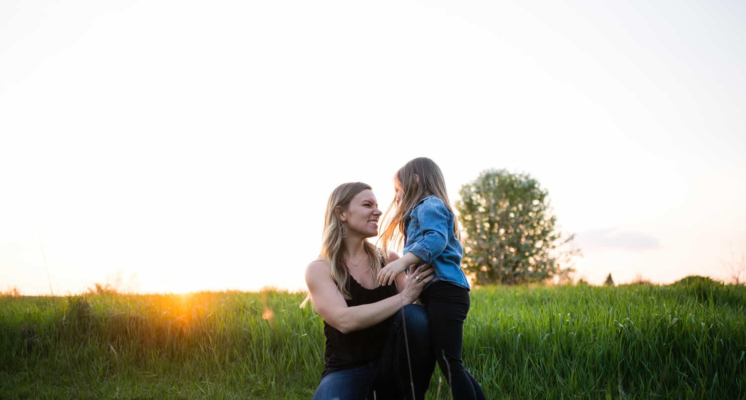 Mother and daughter playing in meadow