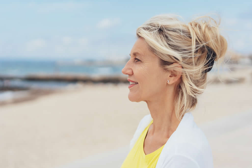 woman on beach looking out to sea