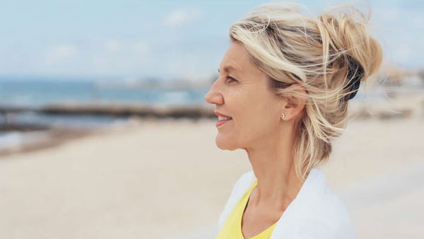 woman on beach looking out to sea