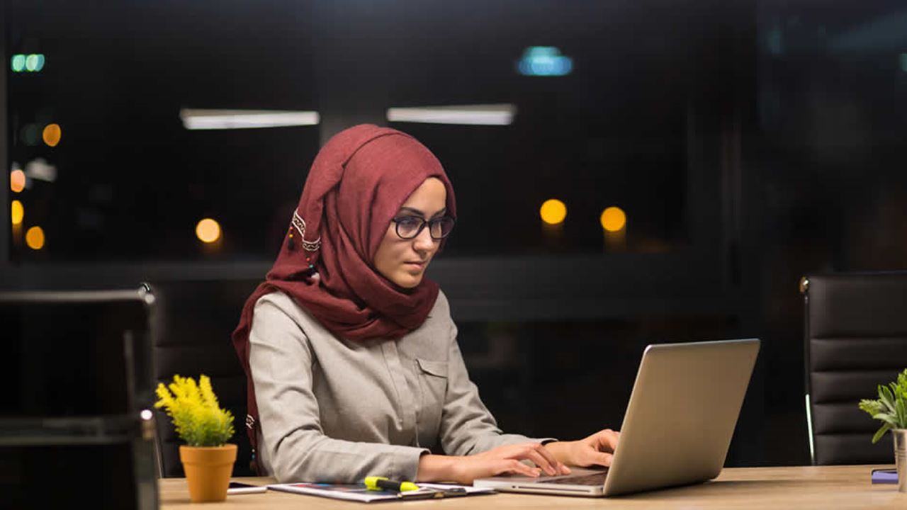 Lady at office desk working on laptop