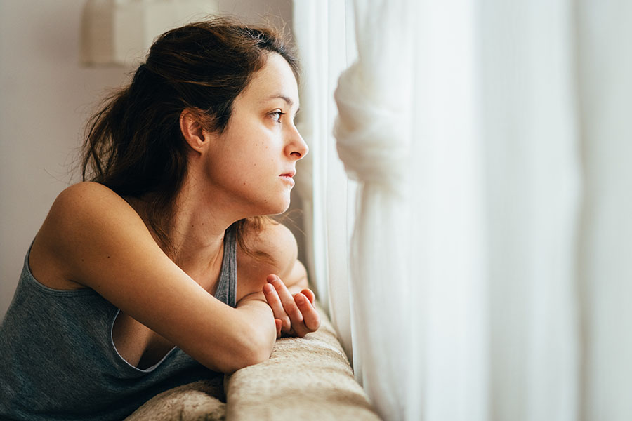 Lady thoughtfully looking out window