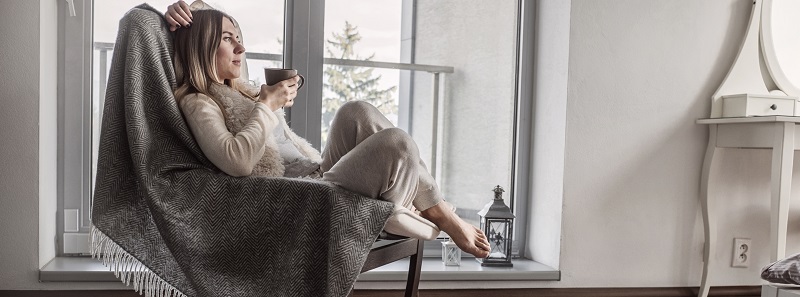 Woman sat in comfortable chair thinking