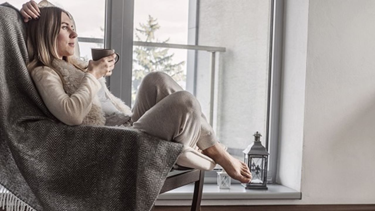 Woman sat in comfortable chair thinking