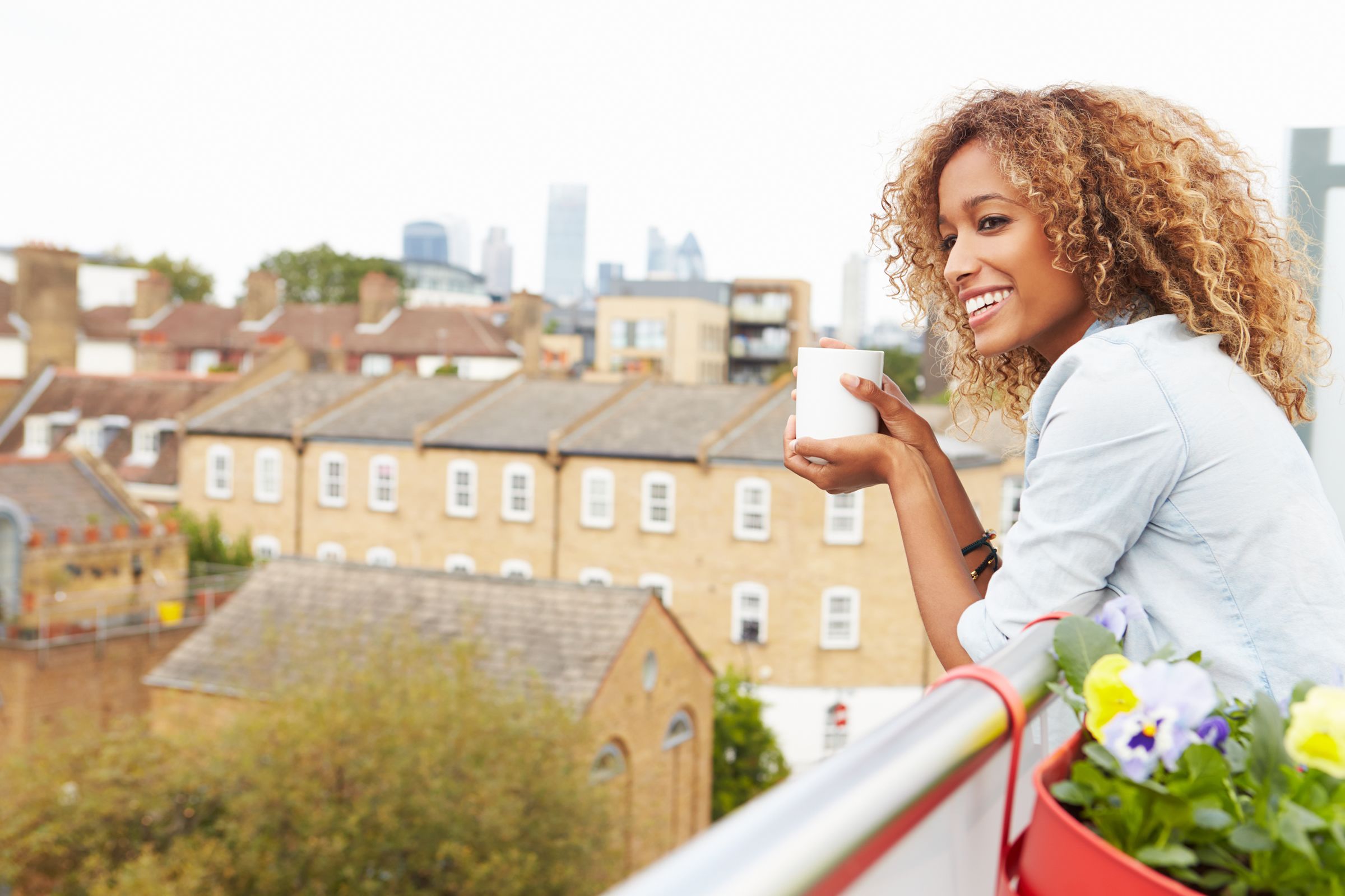 Woman smiling and having a cup of tea
