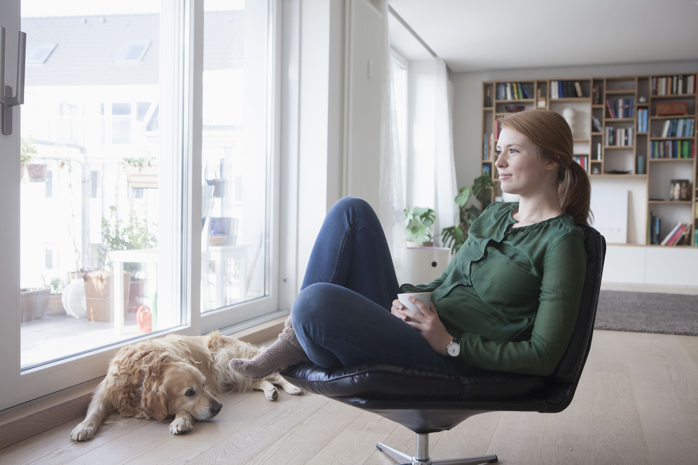 Pensive woman sitting down with a dog