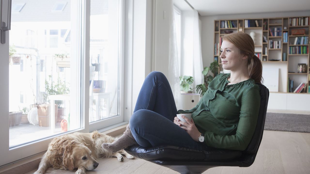 Pensive woman sitting down with a dog