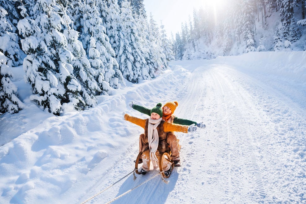 Happy children on a sled in Finland