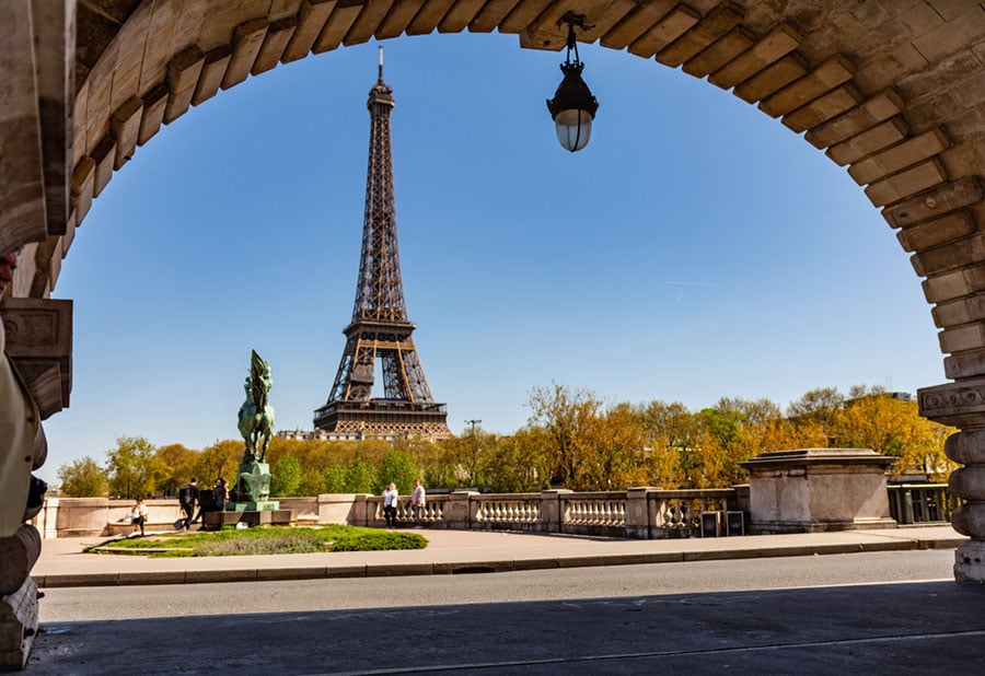a view of the eiffel tower through an archway