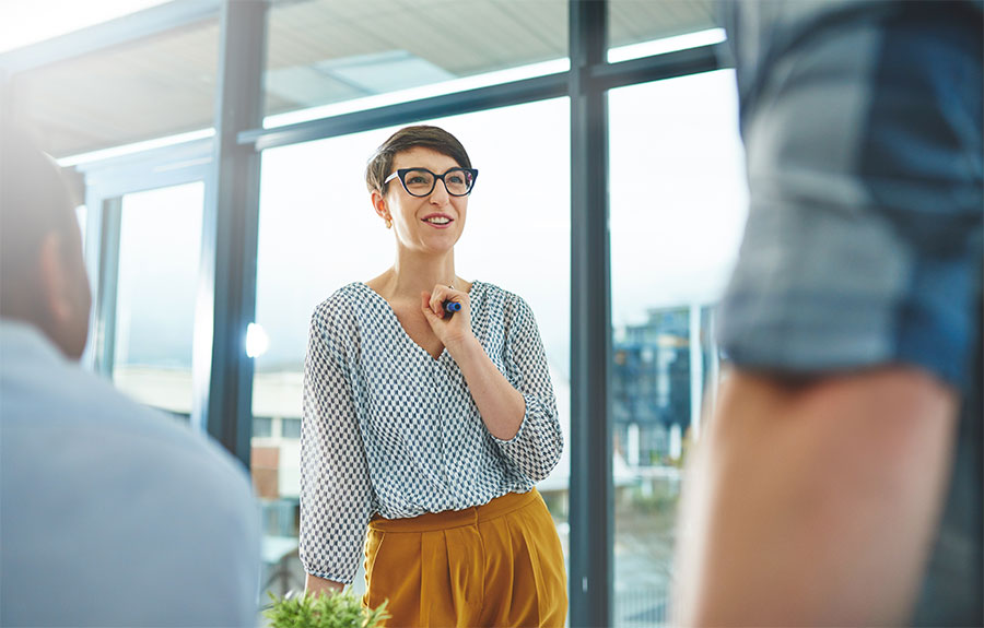 employees chatting in a sunny office