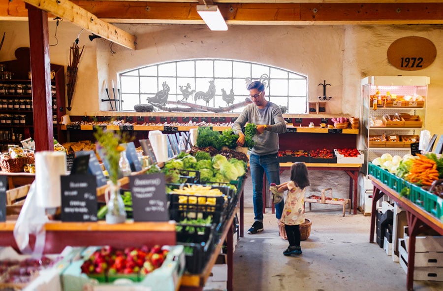 a man and his son in a farmers market