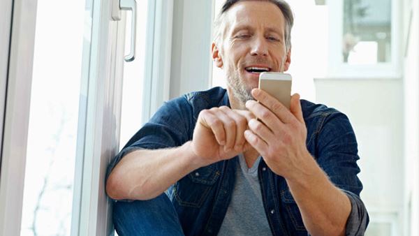 man sitting on a step looking at his phone