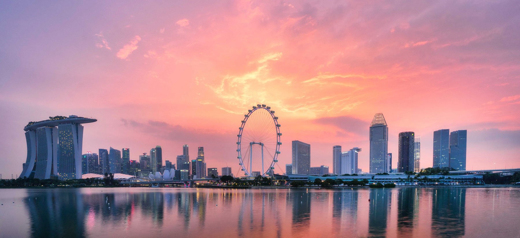 A photo of the Singaporean skyline at dawn
