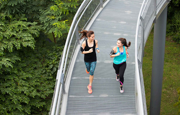 Two women jogging and chatting