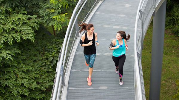 Two women jogging and chatting