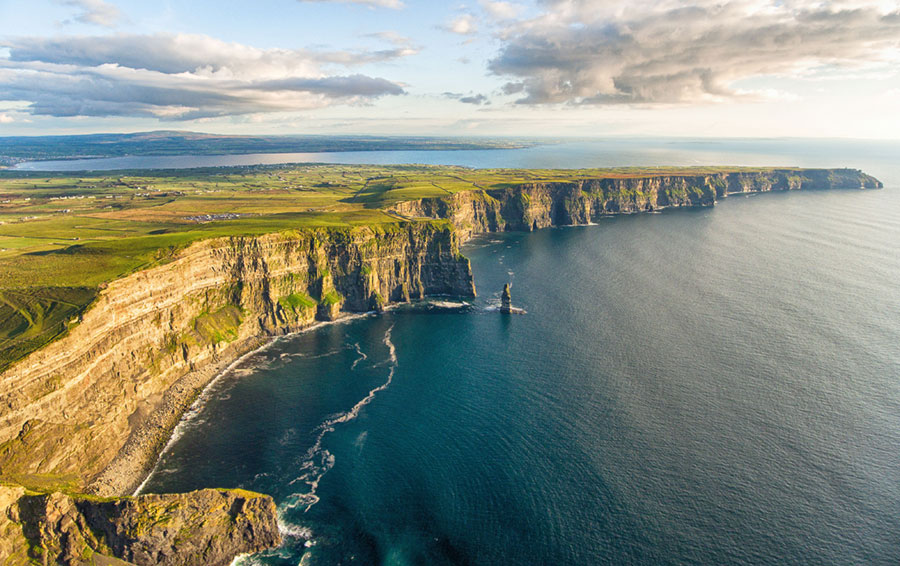sun reflecting off cliffs of wild irish coastline