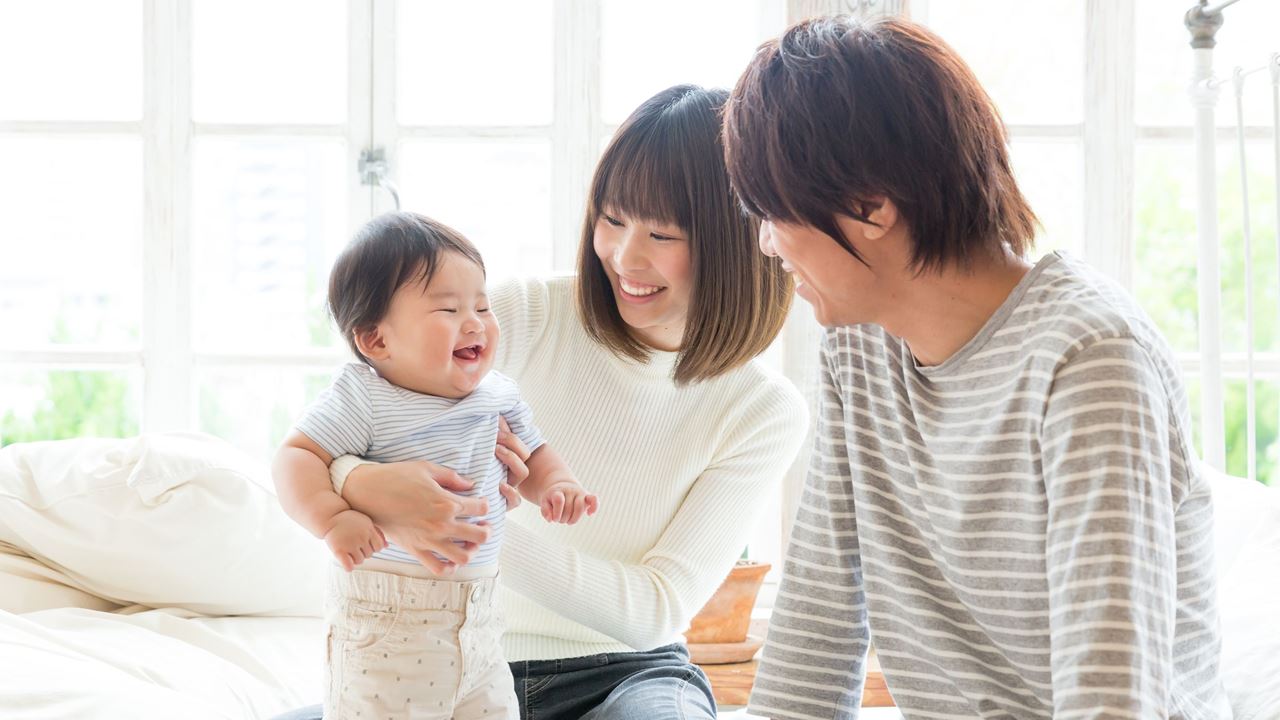 family with smiling baby